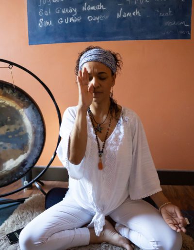 A woman in meditation with her eyes closed.