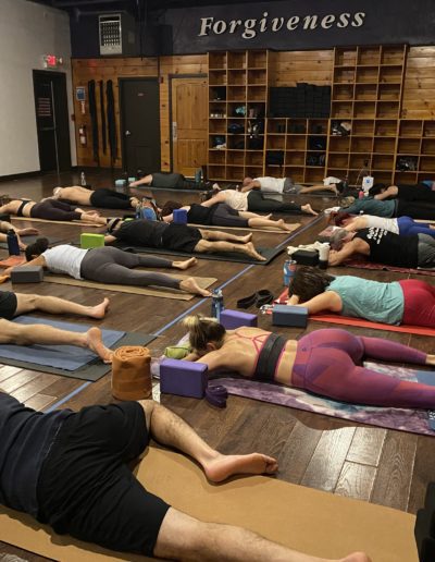 Group in relaxation pose at a yoga session.