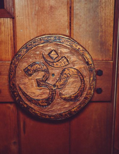 Om symbol carving on wooden door.