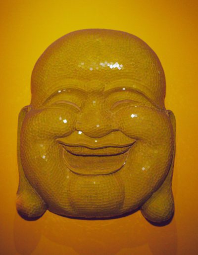 Laughing Buddha statue symbolizing joy and wellness.