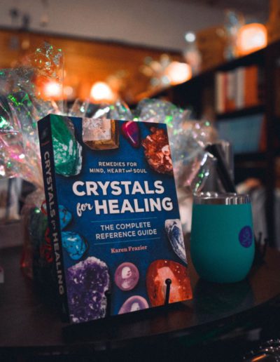 Crystal healing book featured at a wellness shop.