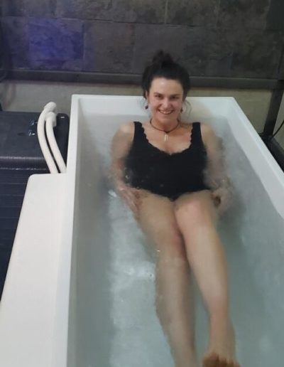 Woman enjoying ice bath in Raffa spa.