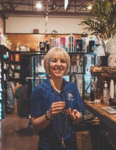 Clerk with mala beads at wellness store