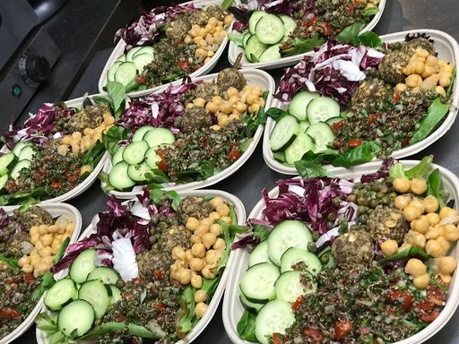 Bowls of quinoa salad with fresh veggies.