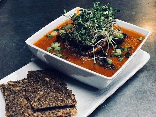 Vegan lentil loaf with tomato sauce and sprouts.
