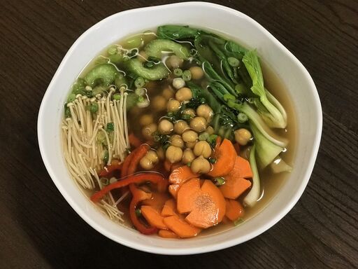 Bowl of vegetable noodle soup with chickpeas.